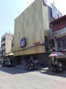 a building with a sign on the side of it at Bedbox Hotel Dagupan in Dagupan