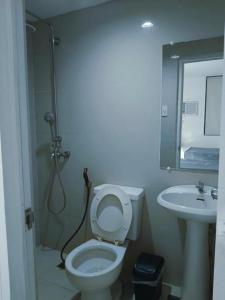a bathroom with a toilet and a sink at Bedbox Hotel Dagupan in Dagupan