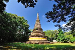 a large pagoda sitting in a field with trees at The Passion Hotel in Chiang Mai +56 photos