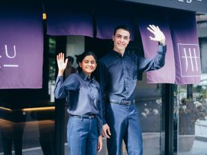 a man and a woman standing in front of a window at MIMARU Kyoto Shinmachi Sanjo in Kyoto