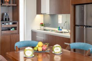 a kitchen with a table with a bowl of fruit on it at Mövenpick Resort Cam Ranh in Cam Ranh
