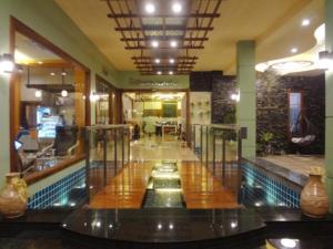 a lobby with a swimming pool in a building at Chodkamol Place 57 in Nakhon Si Thammarat