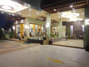 a lobby of a building at night with a building at Chodkamol Place 57 in Nakhon Si Thammarat