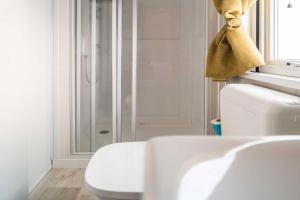 a bathroom with a white toilet and a shower at La Risacca Family Camping Village in Porto SantʼElpidio