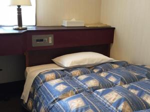 Postel nebo postele na pokoji v ubytování Hotel Town Nishikigawa