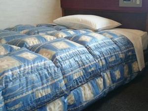 Postel nebo postele na pokoji v ubytování Hotel Town Nishikigawa