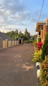 a driveway in front of a house with a garage at Wepick Homes in Kigali