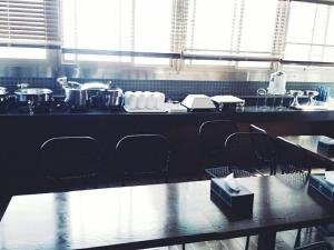 a kitchen with tables and chairs in a restaurant at Hwagok Haedamchae in Seoul