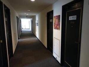 a hallway of a building with two doors and a hallwayngthngthngthngthngth at Personal Hotel You in Takeo