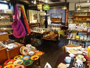 a store with tables and chairs in a room at Personal Hotel You in Takeo