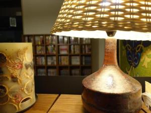 a lamp sitting on a table next to a mug at Personal Hotel You in Takeo