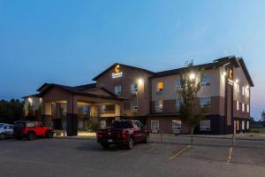 a large building with a truck parked in a parking lot at Comfort Inn & Suites in Virden