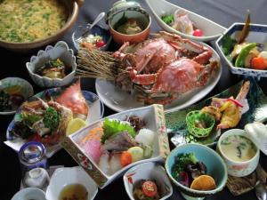 a table with many dishes of food on it at Tara Kanko Hotel in Kamenoura