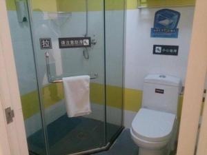 a bathroom with a toilet and a glass shower at 7 Days Inn Beijing South Railway Station in Beijing