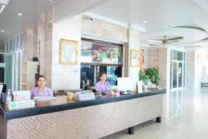 two women sitting at a counter in a restaurant at Century Grand Hotel in Bung Kan