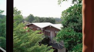 a view of a building from a window at Ban Nai Amphoe in Nakhon Ratchasima
