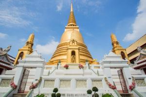 a large golden pagoda with a blue sky in the background at Alameda Suites Hotel in Bangkok +29 photos