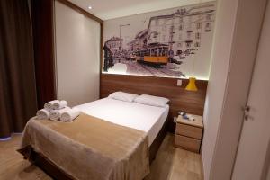 Un pat sau paturi într-o cameră la SP Stays Be Paulista