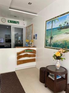 a room with a table and a painting on the wall at Jeffrey S Hotel in Boracay