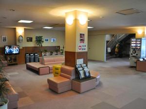 eine Lobby eines Ladens mit Sofas und einem TV in der Unterkunft Senganishi Onsen Yumoto Azumakan in Oniyanagimachi