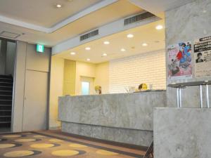 a lobby with a reception desk in a building at Mizusawa Grand Hotel in Oshu