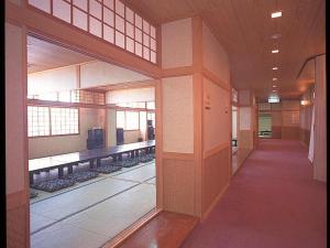 a hallway of a building with a room with at Hokkaido Futomi Meisen Manyo no Yu in Ishikari