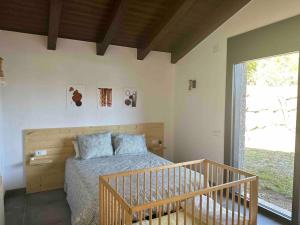 a bedroom with a bed and a large window at Cal Manubens in Castellar del Riu
