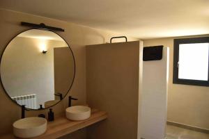 a bathroom with two sinks and a large mirror at Cal Manubens in Castellar del Riu +64 photos