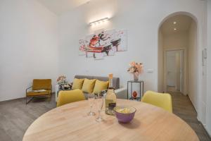 a dining room with a table and yellow chairs at Serenity - Sweet Dreams in Florence in Florence