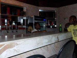 two men standing at a counter in a bar at ROYAL PARAGON HOTEL in Egbelu