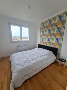 a bedroom with a large bed and a window at T3 cosy proche Paris, tous commerces et Rer à pied in Viry-Châtillon