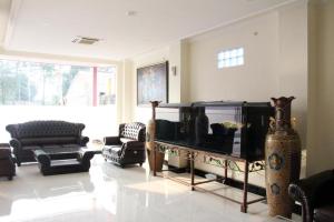 een woonkamer met meubels en een groot aquarium bij Hotel Banggalawa in Jakarta