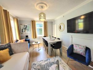 a living room with a couch and a table at 4 Bedrooms Apartment By Sensational Stay Short Lets & Serviced Accommodation in Edinburgh