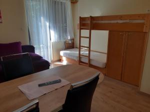 a living room with a table and a bunk bed at Apartma Gaber 110 in Zreče