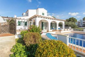 a large white house with a swimming pool at Villa Ursula in Santo Tomás