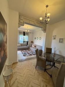 ein Wohnzimmer mit einem Tisch, Stühlen und einem Sofa in der Unterkunft Cozy apartment with roof top in Marrakesch