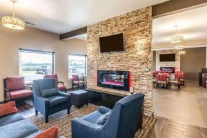 a living room with a fireplace and a tv at Comfort Inn & Suites North Aurora - Naperville in North Aurora