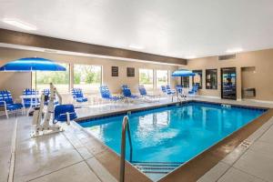a large pool with blue chairs and a poolside at Comfort Inn & Suites North Aurora - Naperville in North Aurora