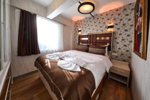 a bedroom with a large bed in a room at By Aydın Suites in Istanbul