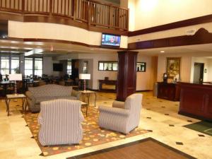 a lobby with chairs and a television in a building at Streetsboro/Cleveland Southeast in Streetsboro