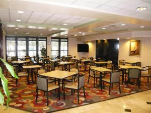 a dining room with tables and chairs on a rug at Streetsboro/Cleveland Southeast in Streetsboro