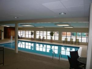 a large swimming pool in a building with chairs at Streetsboro/Cleveland Southeast in Streetsboro