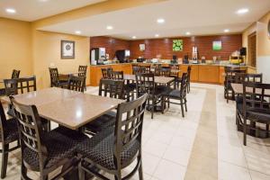 a restaurant with tables and chairs and a kitchen at Chicago O'Hare Airport in Elk Grove Village