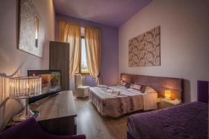 Postel nebo postele na pokoji v ubytování Hotel Palazzo Renieri - 3stelle S + 37 fotografií