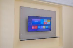 a flat screen tv on a wall at Lucky Hotel İstanbul in Istanbul