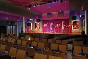 a group of people on a stage in a theatre at Riu Yucatan - All Inclusive in Playa del Carmen