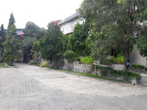 a cobblestone street with trees and a building at Ima hotel in Klapalima