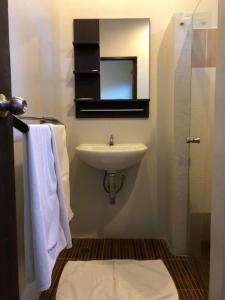 a bathroom with a sink and a mirror and towels at Pawa Place (By Inpawa) in Ban Phai