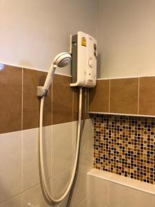 a shower in a bathroom with a blow dryer at Pawa Place (By Inpawa) in Ban Phai