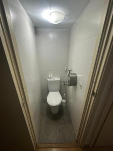 a bathroom with a white toilet in a stall at Gotico Rooms in Barcelona